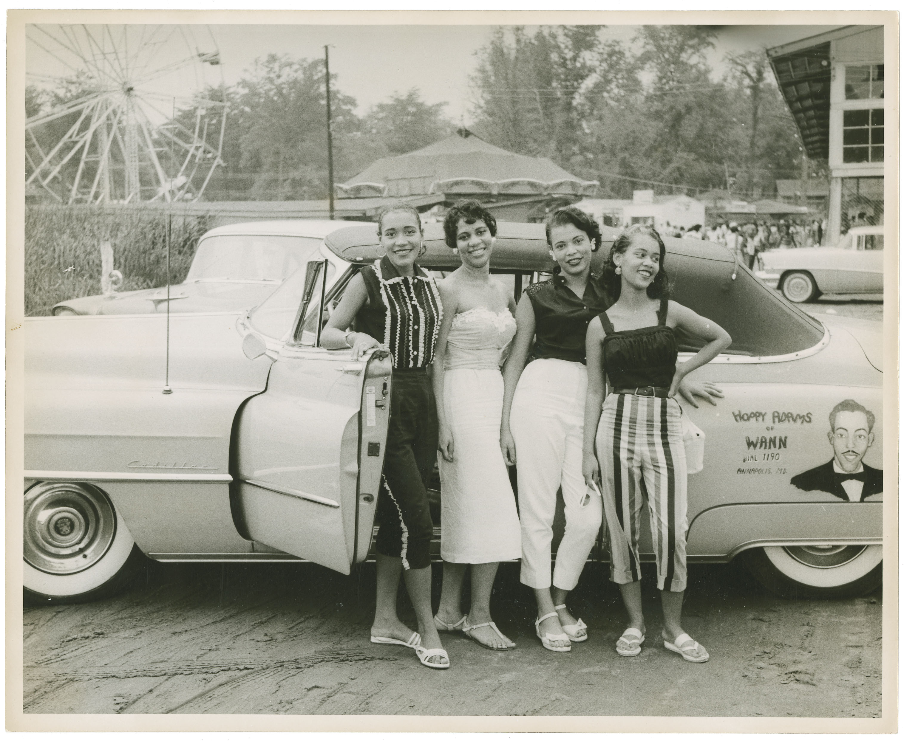 Four girls in front of car