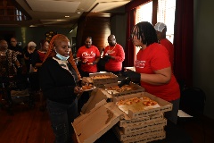 Certified Pies Staff speaks with visitor while handing out their pizza slices