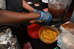 A person prepares food for the Taste of Black Little Rock event