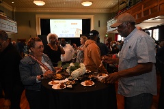Visitors eating from small plates with treats at the Taste of Black Little Rock event